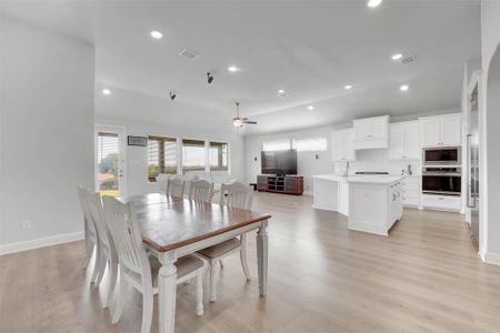 Dining room with ceiling fan, light wood-type flooring, and sink