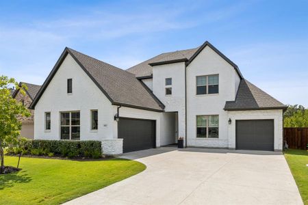 View of front of property with a garage and a front yard