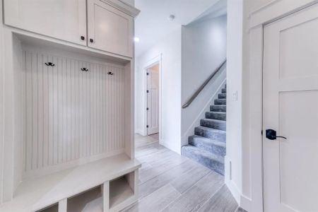 Mudroom with light hardwood / wood-style flooring