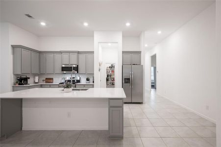Modern open concept kitchen with a large island, perfect for entertaining, featuring high-end appliances and ample counter space.