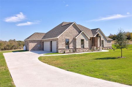 View of front of home with a garage and a front yard