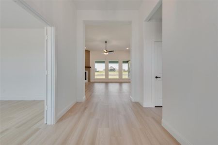 Hallway featuring french doors and light wood-type flooring