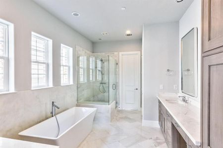 Stunning spa like primary bathroom with upgraded freestanding tub.