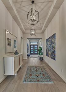 Bright and airy, this spacious home office features elongated windows which invite the soft morning sunlight to illuminate the room. Note the 8' doors throughout this nearly new Perry Home!