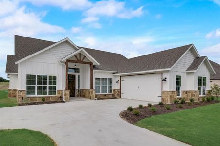 View of front of house with a garage and a front lawn