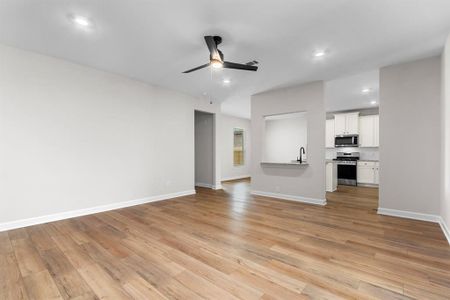 The open floor plan living room flows into the kitchen.