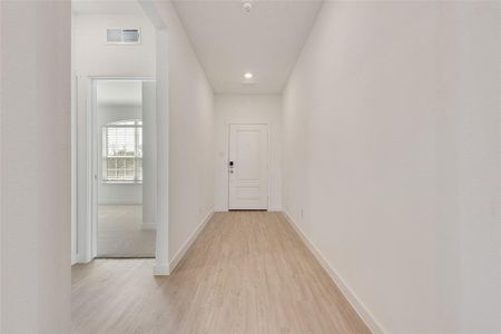 Hall featuring light hardwood / wood-style flooring