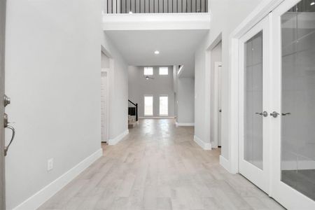 Grand entrance with premium floors, high ceilings, and large base boards. Sample photo of completed home with similar floor plan. Actual colors and selections may vary.