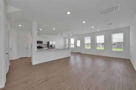 Open concept family room and kitchen.  Vinyl flooring, tons of natural light, 2-inch blinds and overlooks the HUGE back yard.