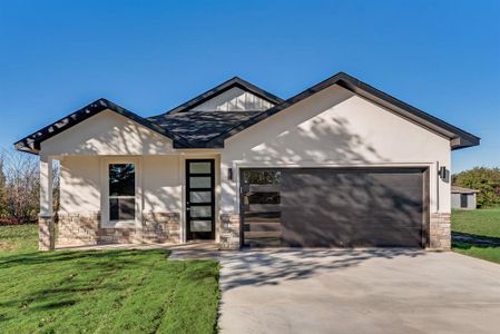 View of front of house with a garage and a front yard