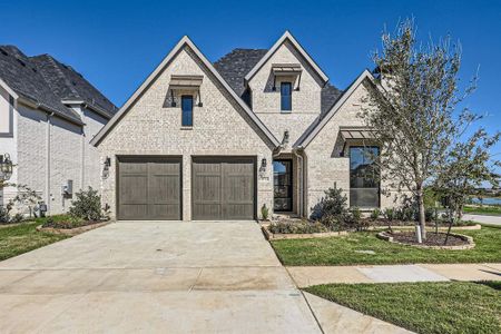 View of front of property with a front yard and a garage