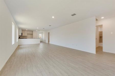 Unfurnished living room featuring light wood-type flooring