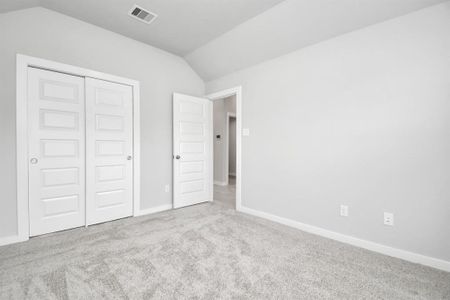 Generously sized secondary bedrooms, complete with spacious closets and soft, inviting carpeting. Enjoy abundant natural light streaming in through the large windows. Sample photo of completed home with similar plan. Actual color and selections may vary.