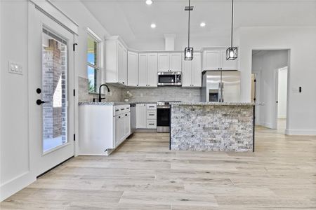 Kitchen with all NEW stainless steel appliances including refrigerator