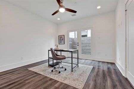 The first-floor bedroom features access that opens directly to the fenced backyard.