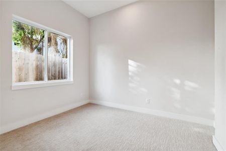 The first floor room displays oversized windows that light up the space.