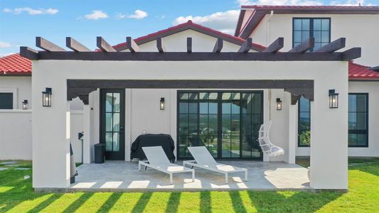 Rear view of house featuring a patio and a lawn