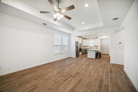 A view from the back door into the kitchen. Roomy living area, eat in kitchen, and bar!