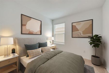 Bedroom featuring light carpet