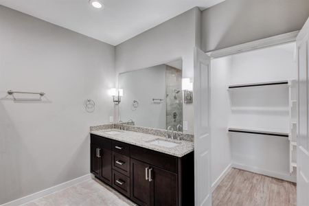 Bathroom with walk in shower, hardwood / wood-style floors, and dual bowl vanity