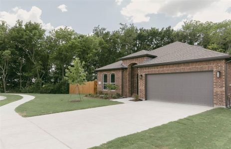 View of front of home featuring a garage and a front yard