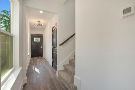 Entryway featuring dark hardwood / wood-style flooring and a chandelier