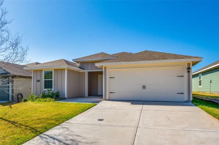 View of front facade with a front lawn and a garage