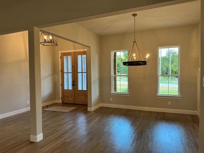 Entrance foyer featuring a notable chandelier, dark hardwood / wood-style floors, and plenty of natural light