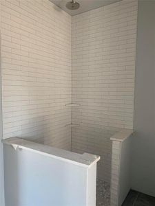 Bathroom with a tile shower and tile patterned floors