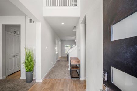 Walking in, you are greeted by a light and open entryway with 2 story ceilings, modern finishes, wood like flooring, and neutral paint.