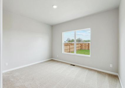 The master bedroom has a great view of the fully-fenced back yard.