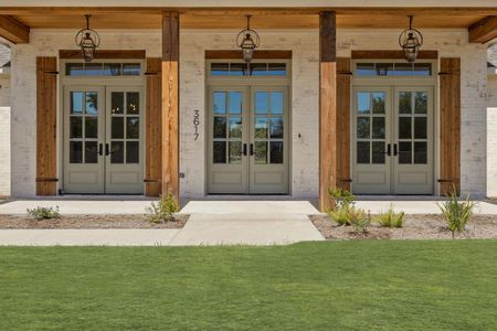 Property entrance featuring french doors and a yard