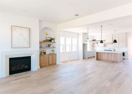 Unfurnished living room with light wood-type flooring and sink