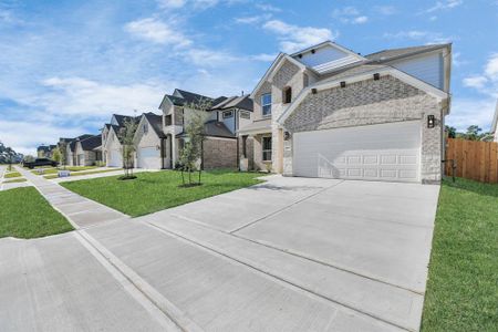 Home showcases a convenient 2-car garage paired with a spacious driveway, providing ample room for parking.