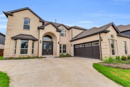 French country home featuring a garage