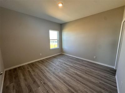 Spare room with dark hardwood / wood-style flooring