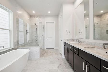 Natural light fills the primary bathroom.  This photo is from a previous build with similar finishes.