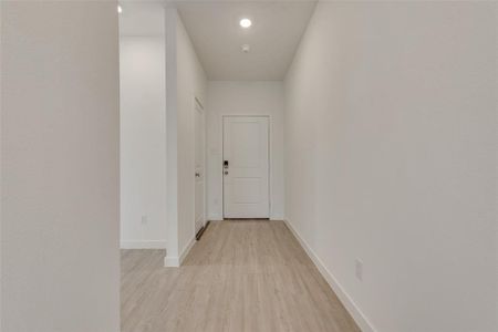 Corridor featuring light wood-type flooring