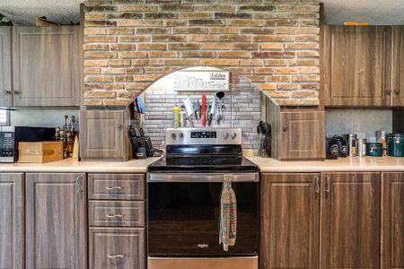 Kitchen featuring stainless steel appliances and a textured ceiling