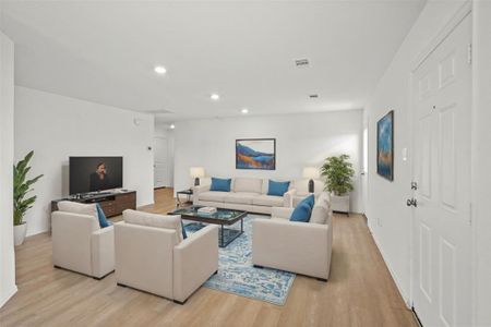 Gather the family and guests together in your spacious living room! Featuring wood like flooring, recessed lighting, fresh paint, and bright natural light. *This room has been virtually staged