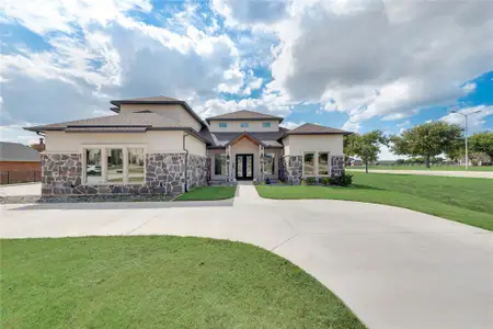 View of front of house featuring a front lawn and french doors