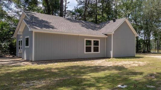 Home is surrounded by a natural setting with mature trees with plenty of natural light.