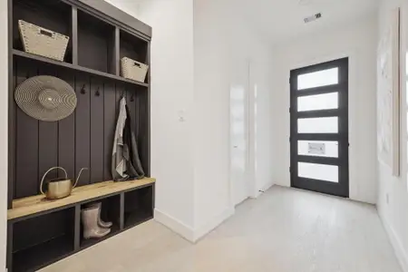 Upon entry into this beautiful model home, you will find a quaint mudroom space/accent wall, gorgeous white oak hardwood floors, and bright LED lighting complete with 1st floor living!