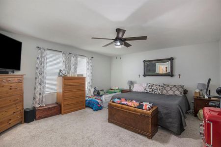 Bedroom with carpet and ceiling fan