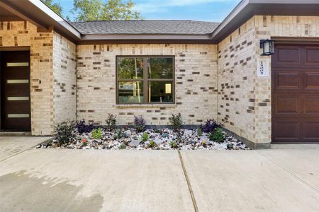 The exterior of the house features a combination of brick and stone on all sides.