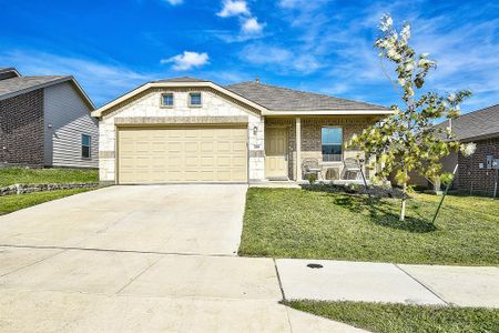 View of front of property with a garage and a front lawn