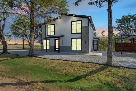 View of front of property featuring a yard and a carport