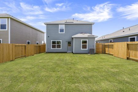 Back of property with a lawn and central air condition unit