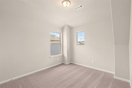 Your secondary bedroom features plush carpet, fresh paint, closet, and a large window that lets in plenty of natural lighting.