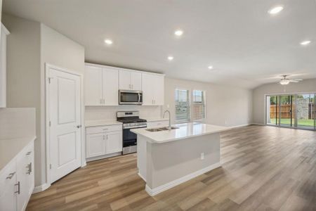 Sit at the kitchen island, or there is a space for your dining table and chairs. You'll love the Simply White Quartz Countertops!